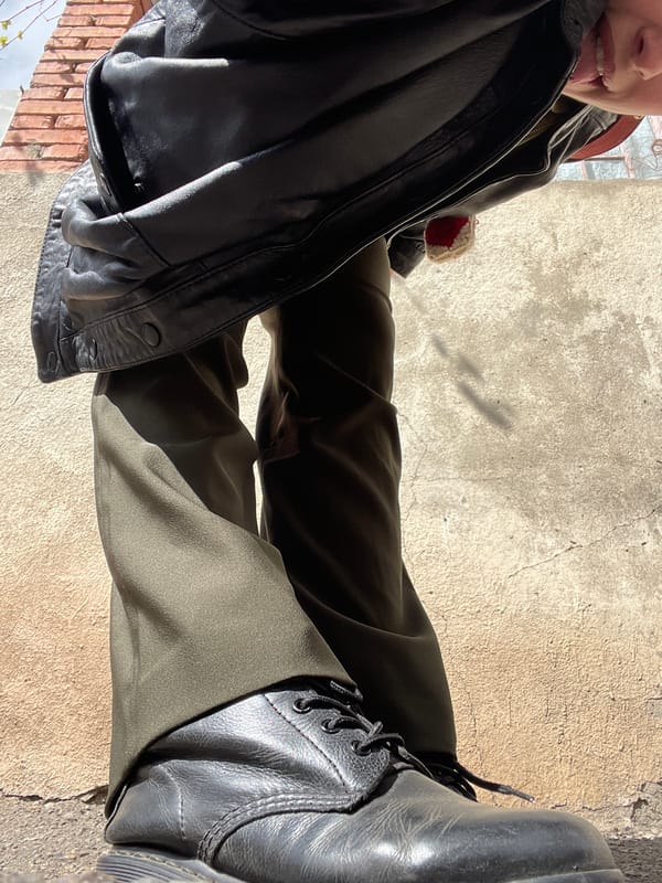 Woman takes selfies in black leather jacket in Tbilisi