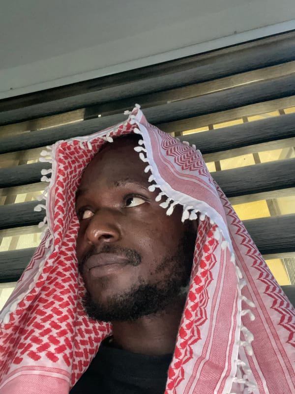Quiet portrait session in Abuja featuring a red and white keffiyeh