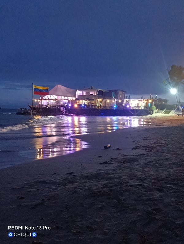 Evening beach documentation captures Pampatar waterfront transition to nighttime