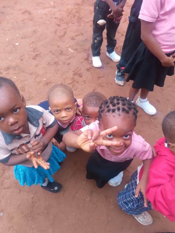 School kids in uniform gather outside in Onitsha, Nigeria