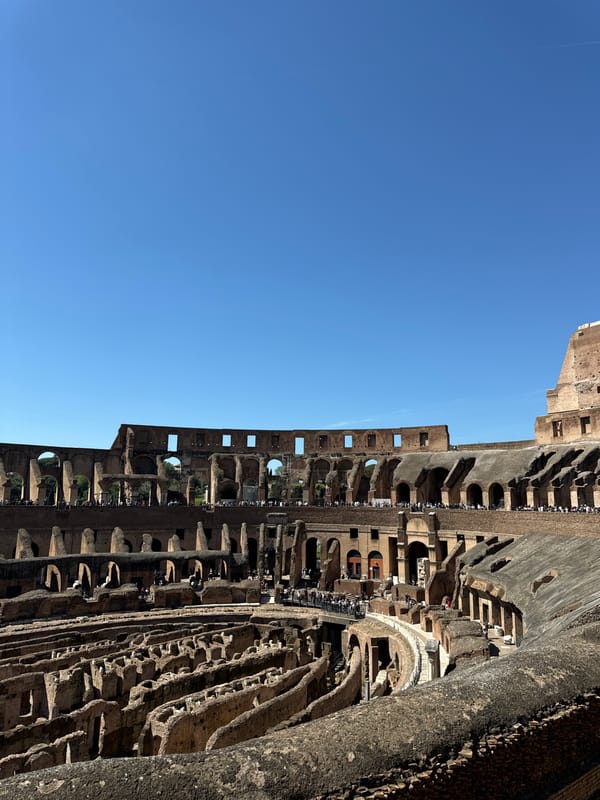 Tourists explore Colosseum ruins on sunny Sunday morning