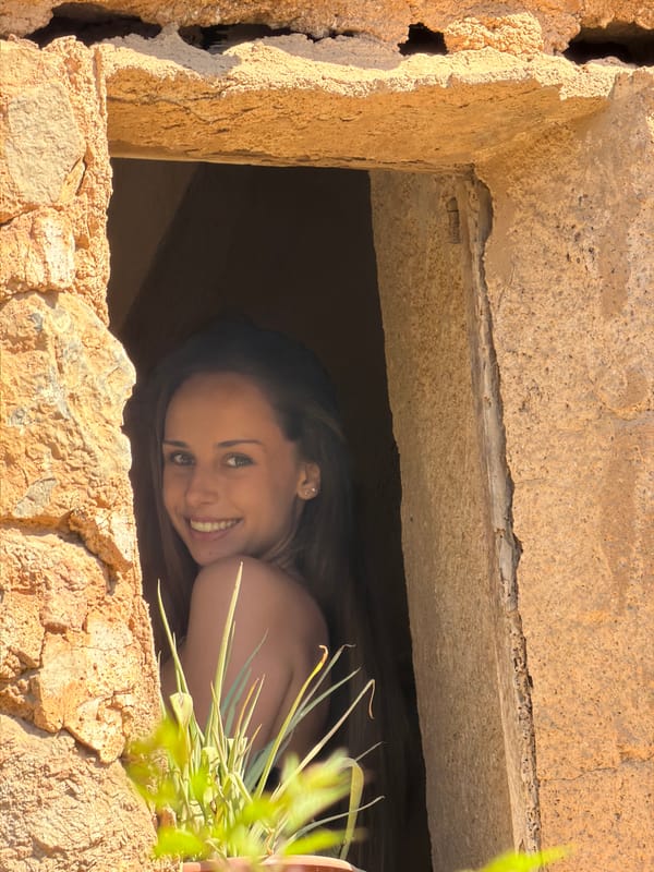 Woman photographed at historic stone structures in Bunyola, Spain
