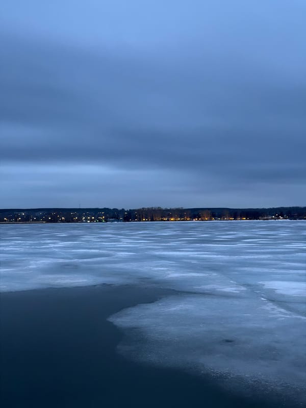Twilight scenes captured across frozen Votkinsk, Russia including piano sculpture
