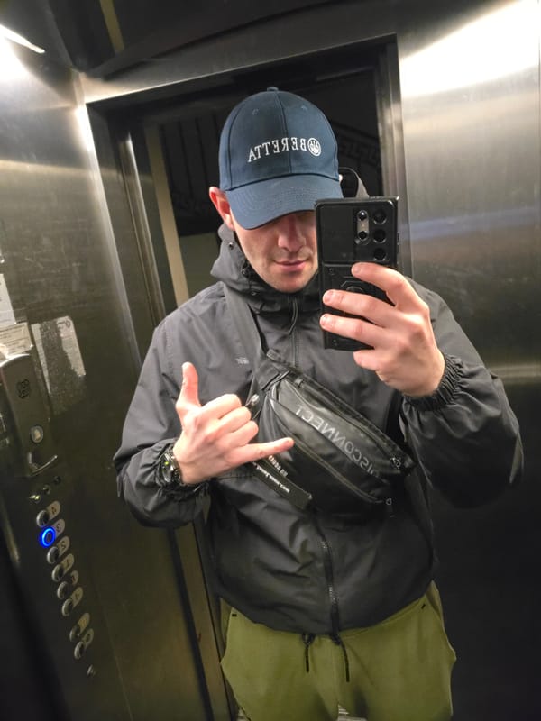 Man takes selfie in Sofia elevator wearing branded clothing