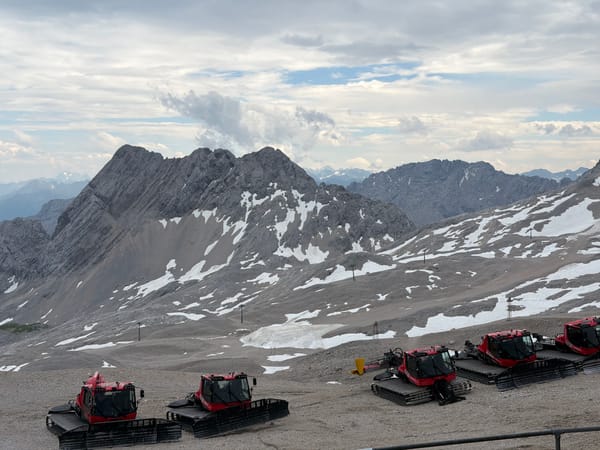 High-altitude Garmisch summit: peaks, cable car, and snow groomers