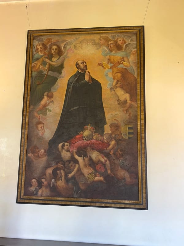 Visitor documents religious art, ornate ceiling at Borgia Palace
