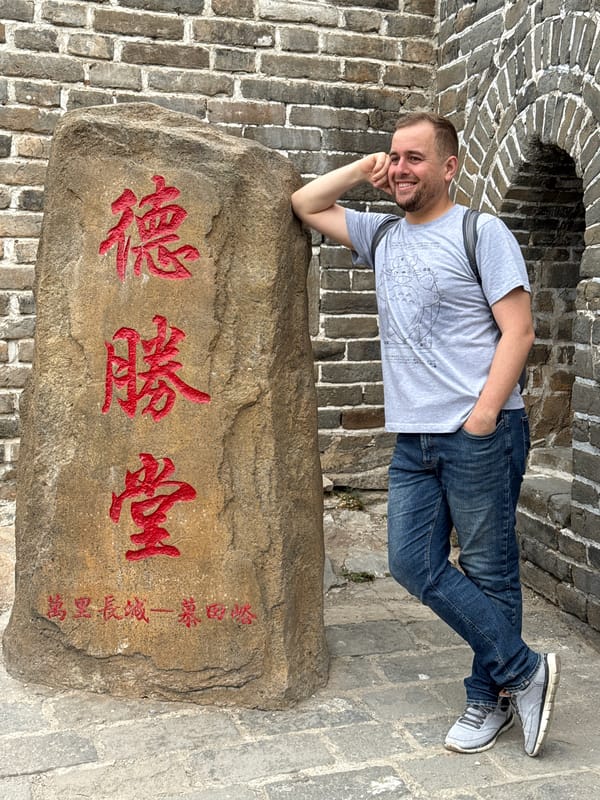 Visitor rests at Great Wall stone marker in Huairou