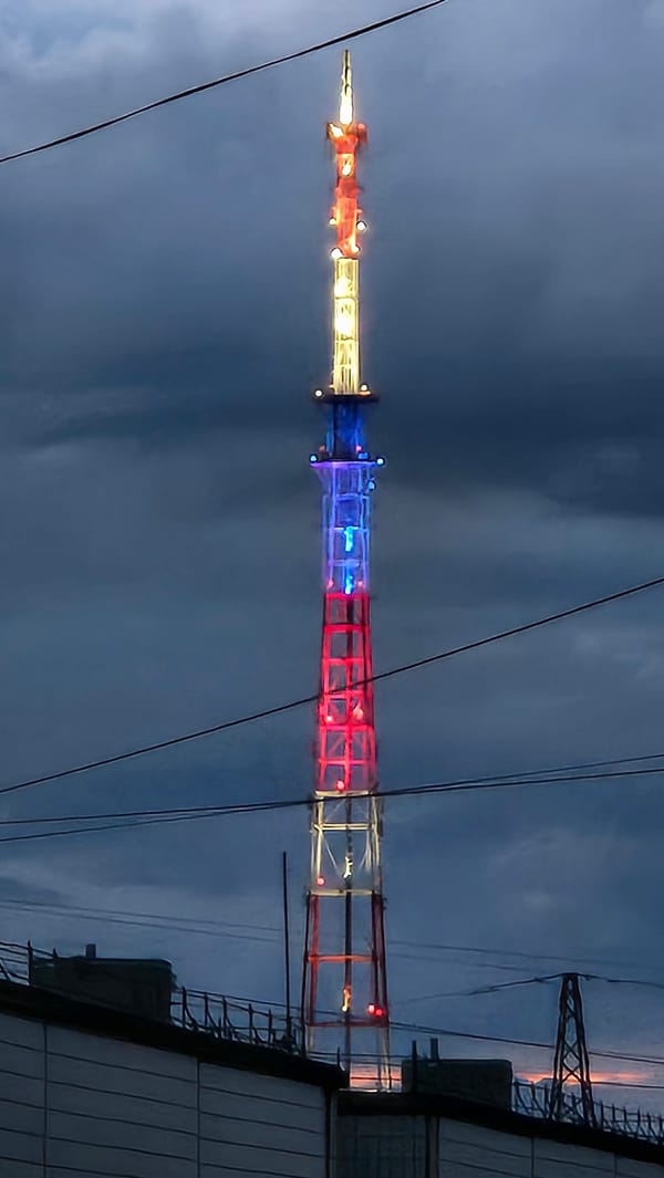 Patriotic-lit tower observed against dark evening sky