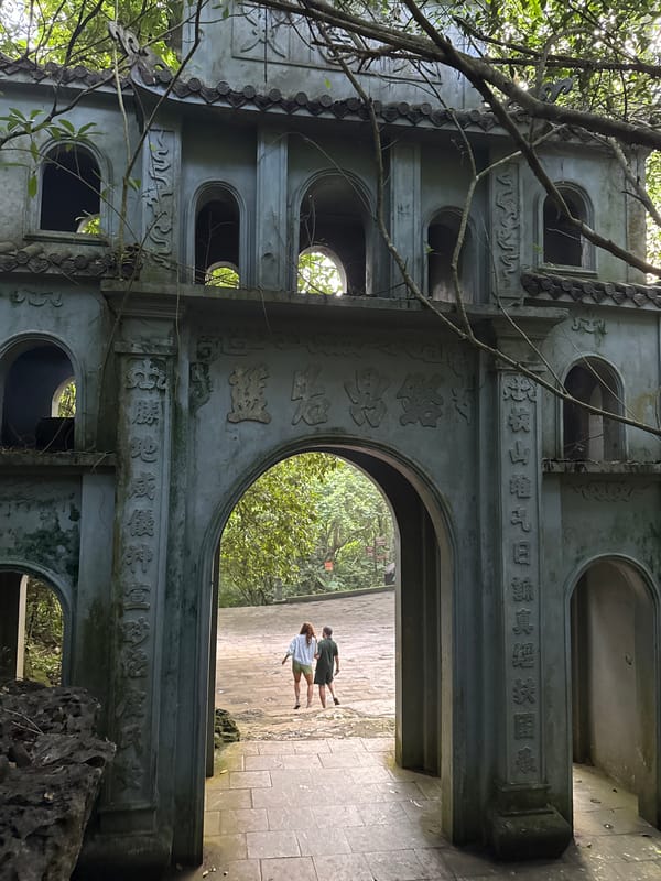 Tourists explore ancient temple grounds in Vietnamese ward