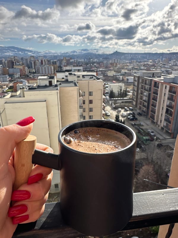 Morning breakfast routine documented in Tbilisi apartment overlooking cityscape