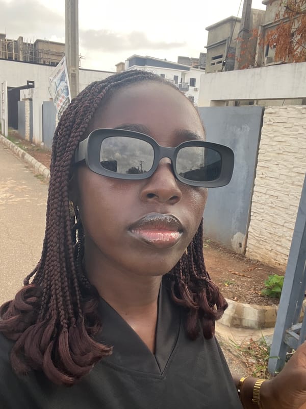 Person takes selfies on residential street in Karum, Nigeria