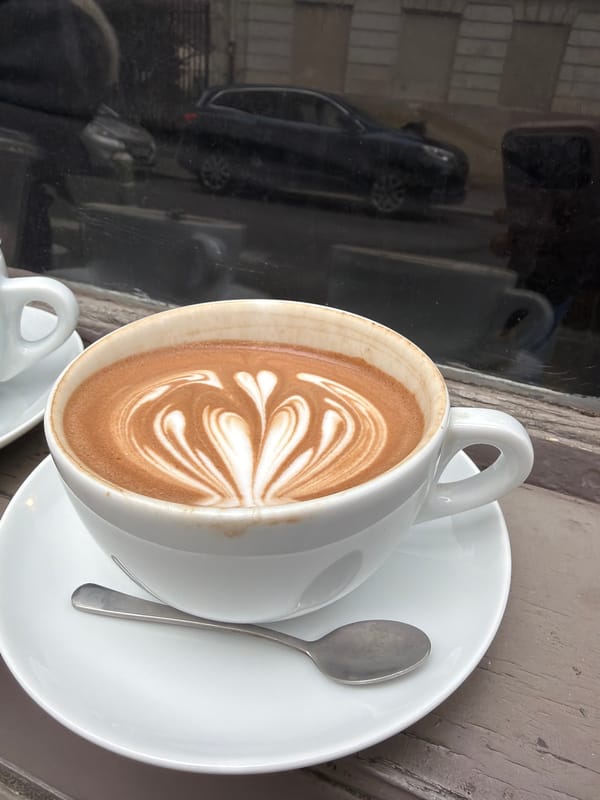 Coffee moment captured at Paris café with artistic latte