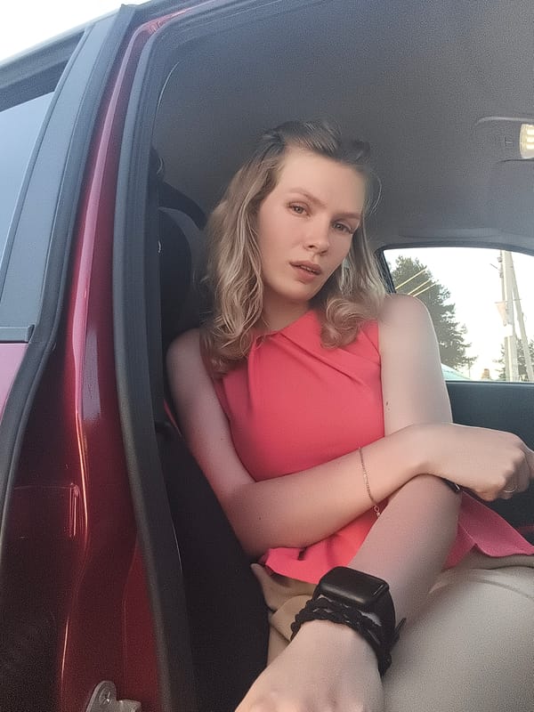 Person in pink top observed in red car in Russia