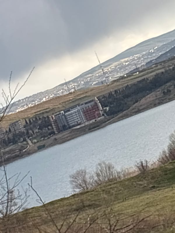 Building complex photographed along waterway in Tbilisi