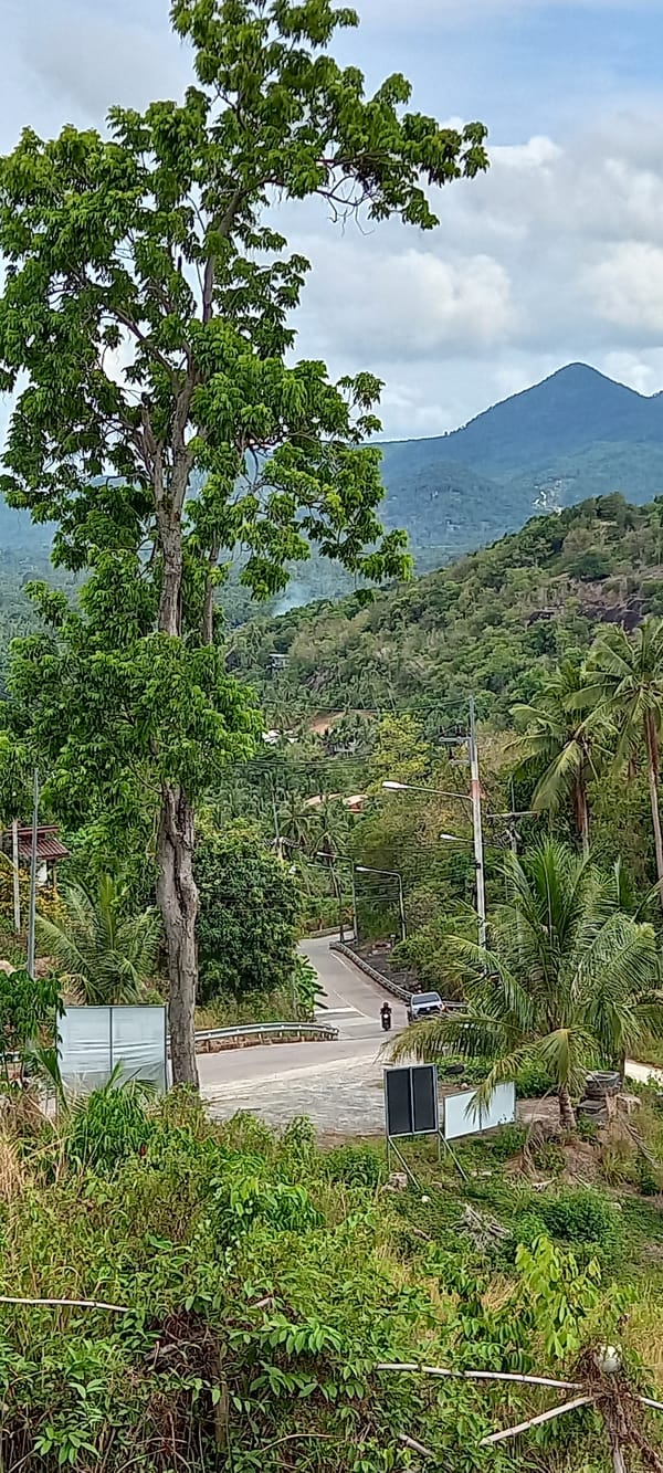 Motorcycle travels mountain road in Baan Tai, Thailand