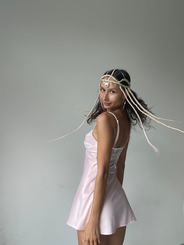 Pink slip dress and beaded braids in a Mũi Né studio shoot