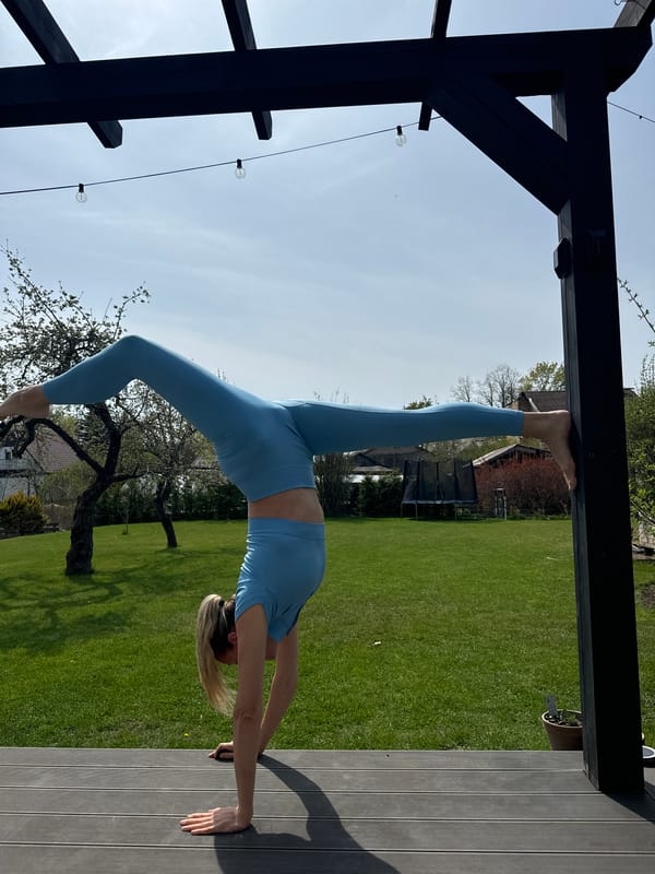 Woman practices outdoor yoga and acrobatics in Carnikava