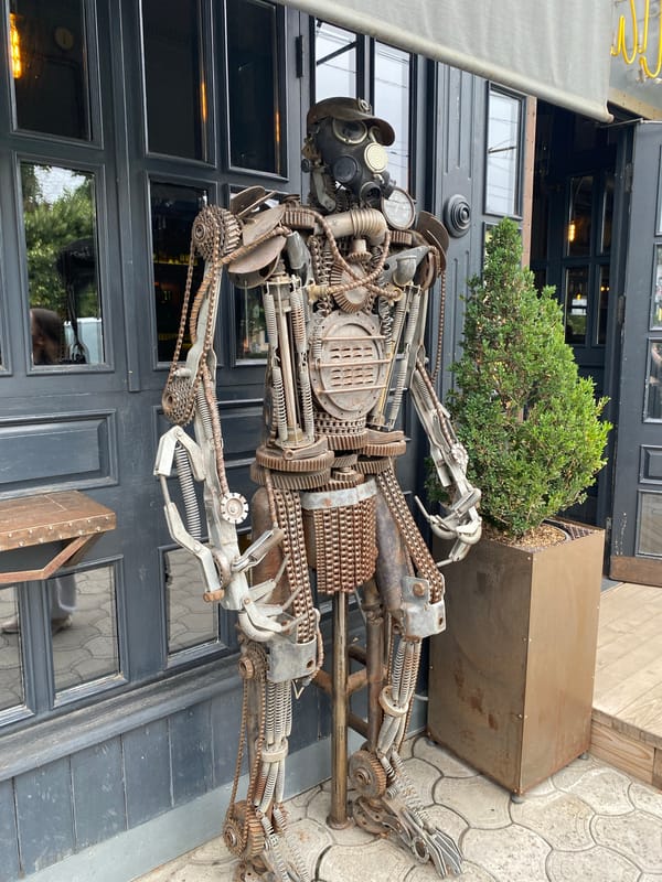 Scrap metal steampunk robot sculpture outside a Mykolaiv building