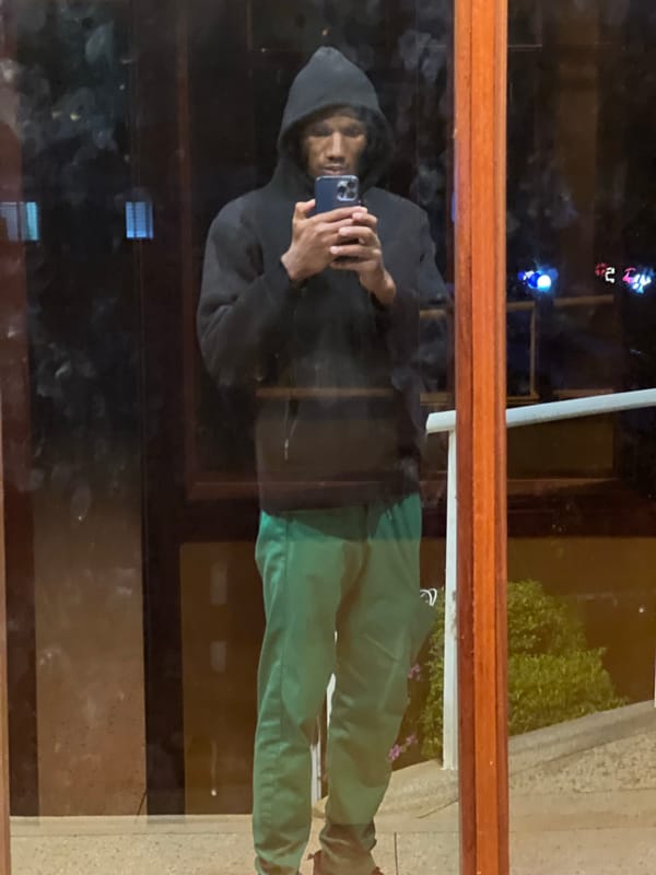 Person takes selfie in window reflection in Nairobi