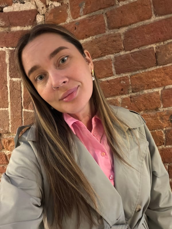 Woman takes selfies near brick wall in Moscow