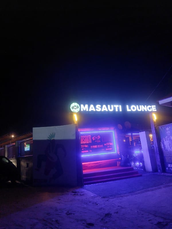 Masauti Lounge illuminated signage captured at night in Dar es Salaam