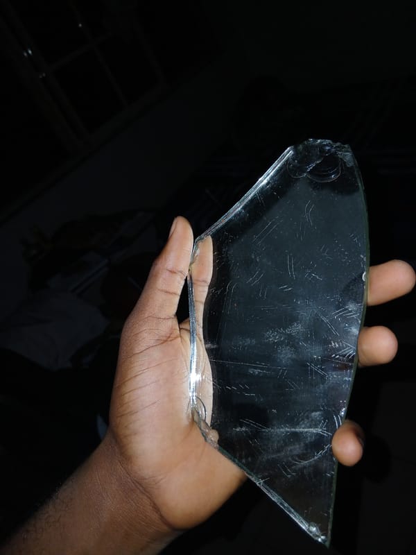 Person handles broken glass, damaged phone in Lagos incident