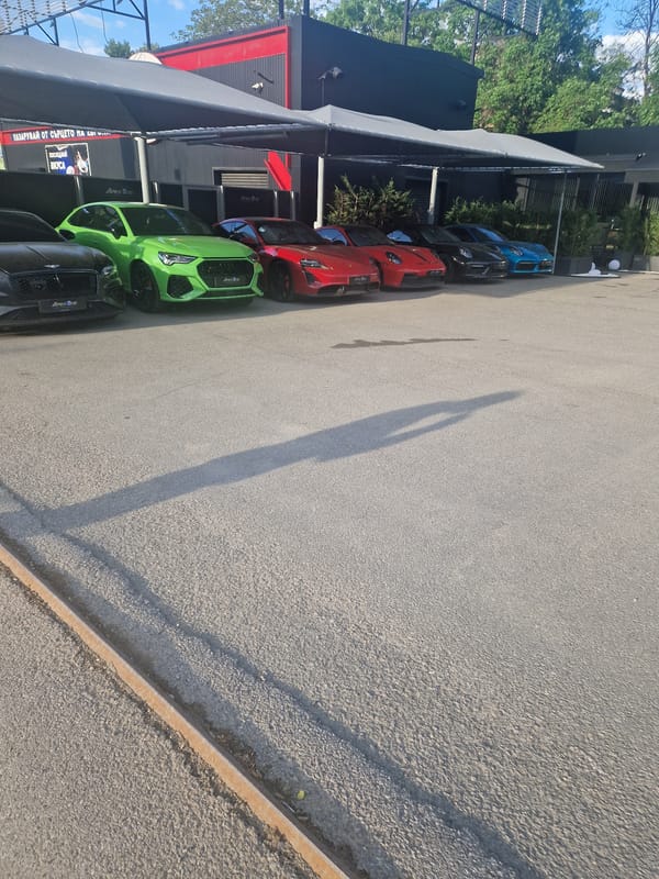 Colorful cars parked alongside building captured in everyday scene