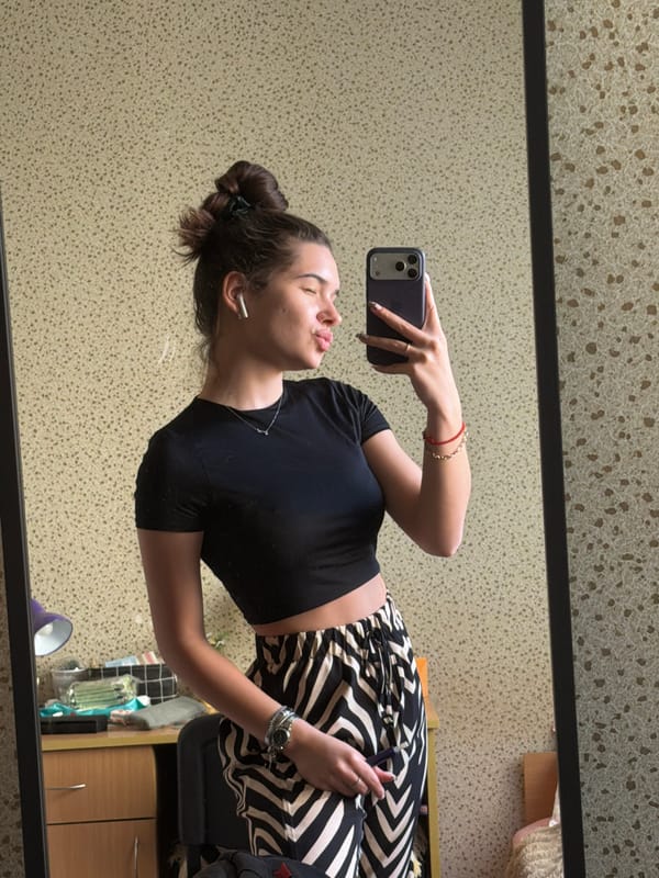 Woman takes selfies in Sofia apartment overlooking cityscape