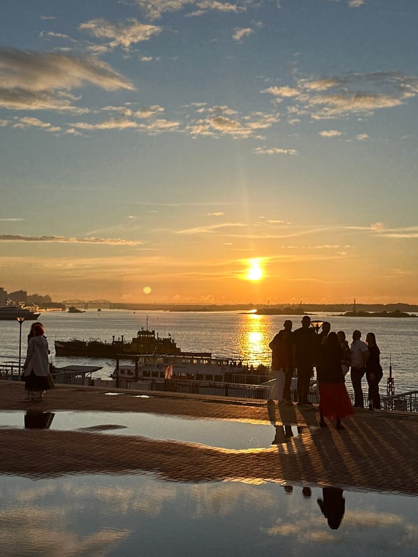Golden hour on an urban waterfront promenade at sunset