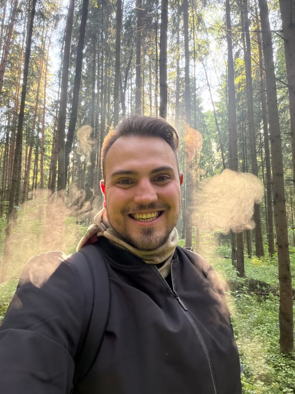 Man takes smiling selfie in Russian forest near Troitsk