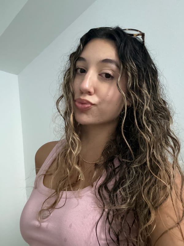 Portrait in Boca Raton, pink top and tortoiseshell frames