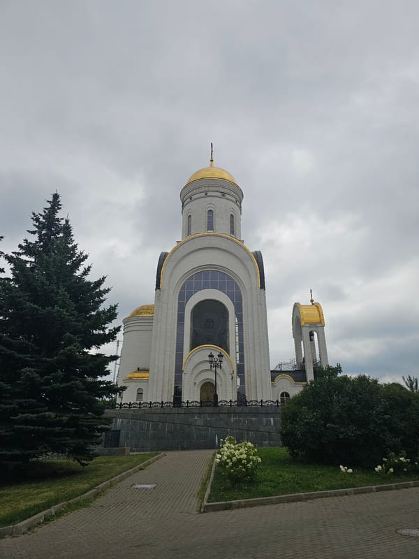 Resurrection Church's white and gold exterior under cloudy skies