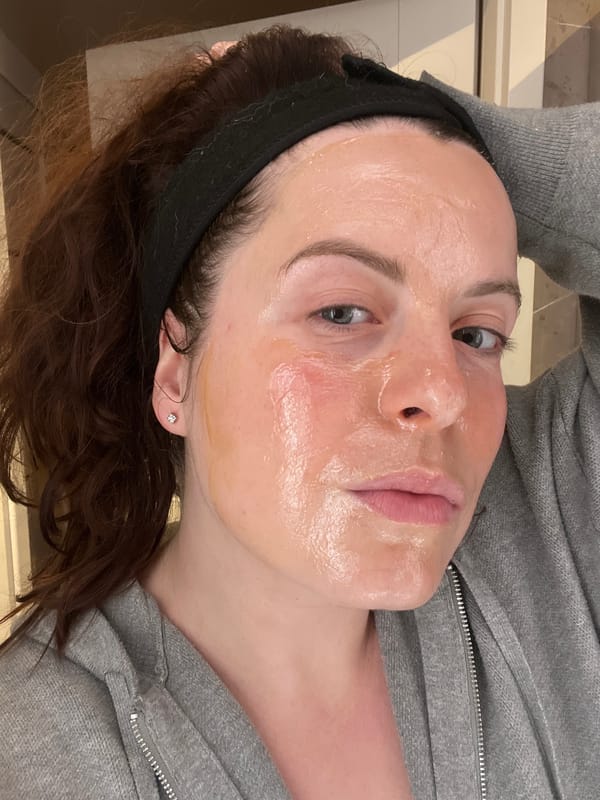 Woman applies skincare treatment during evening routine in Gangloff