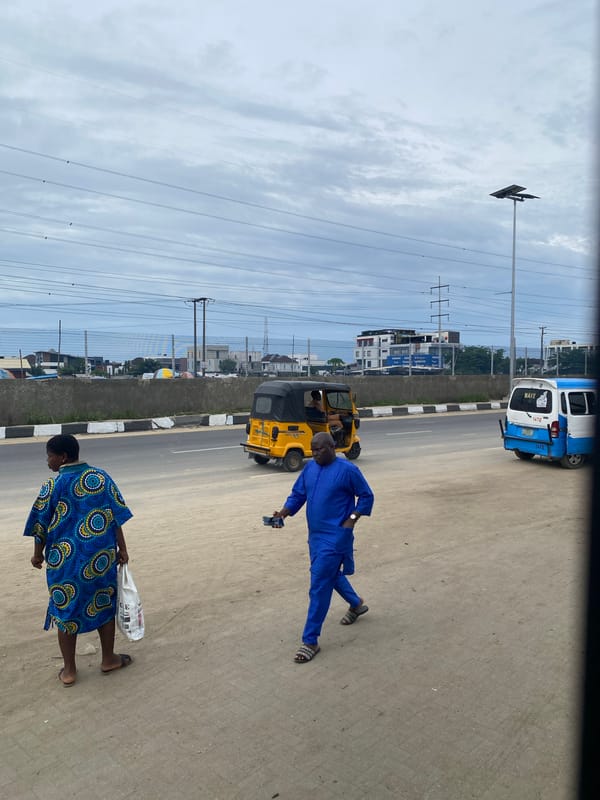 Morning pedestrians walk along Lekki street amid light traffic