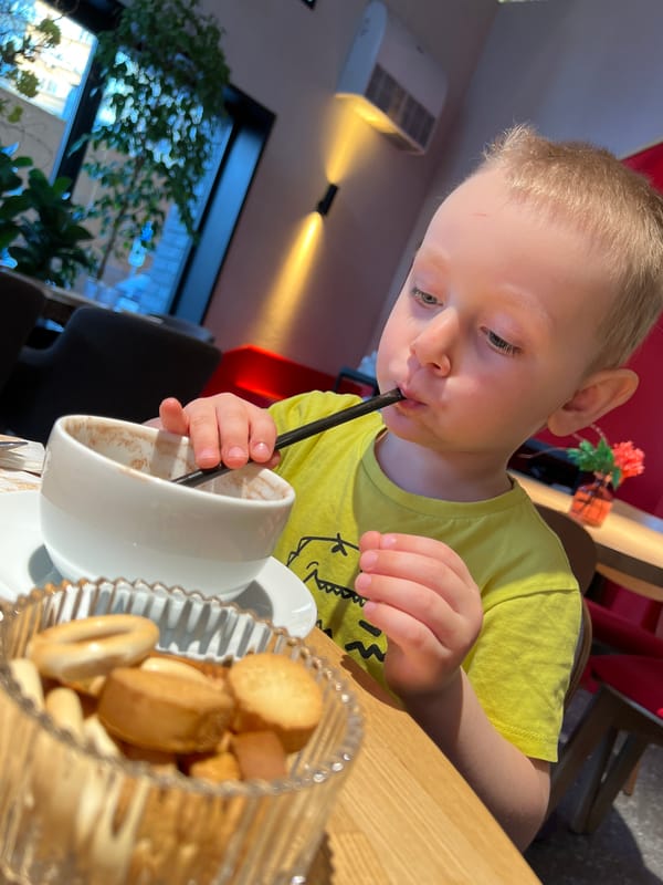 Child enjoys hot chocolate at Mytishchi cafe