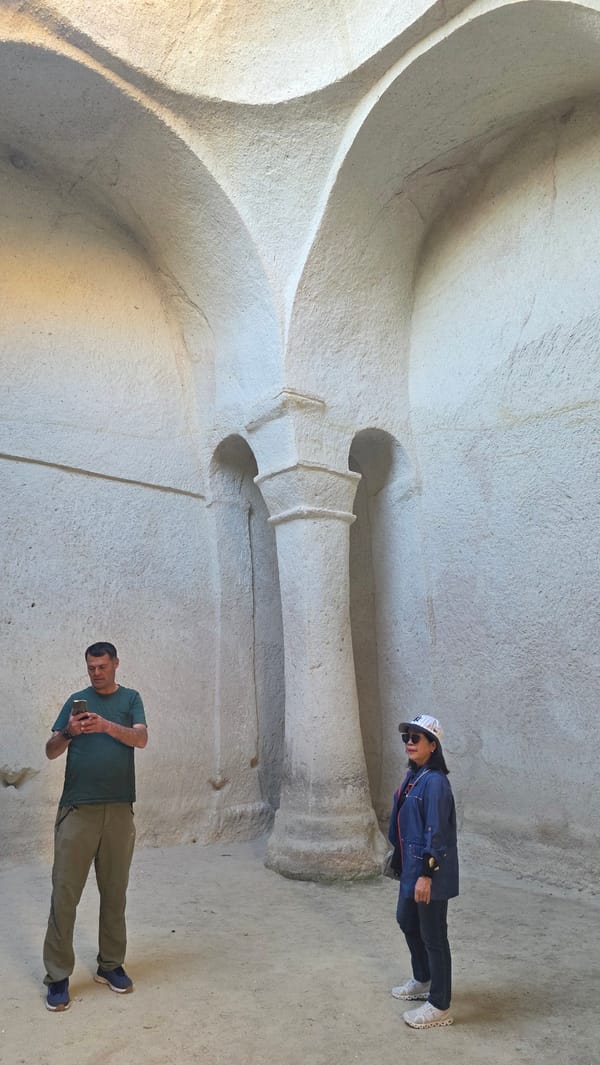 Tourists explore ancient rock-cut churches in Ürgüp, Turkey
