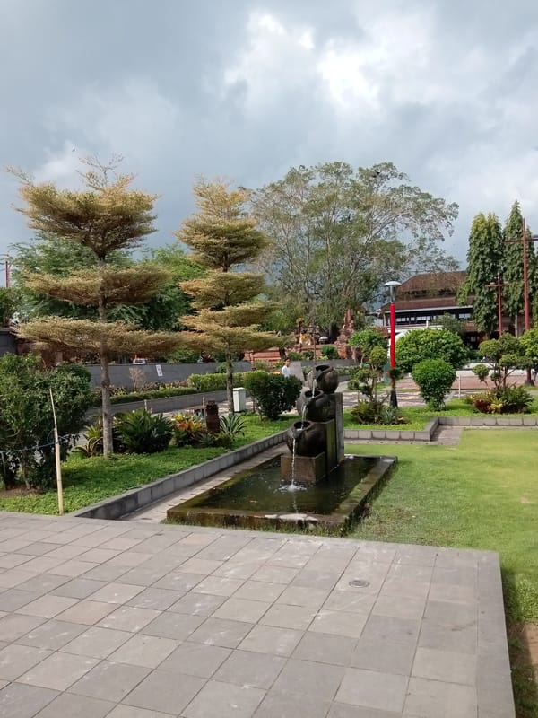 Balinese civic grounds in Gianyar, soldiers marching and statues on display