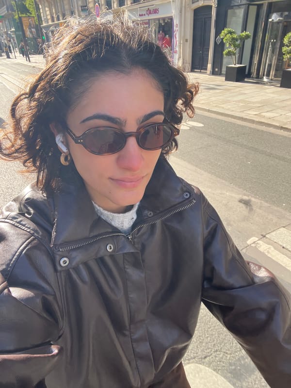 Woman takes morning selfies on Paris street near electric scooter