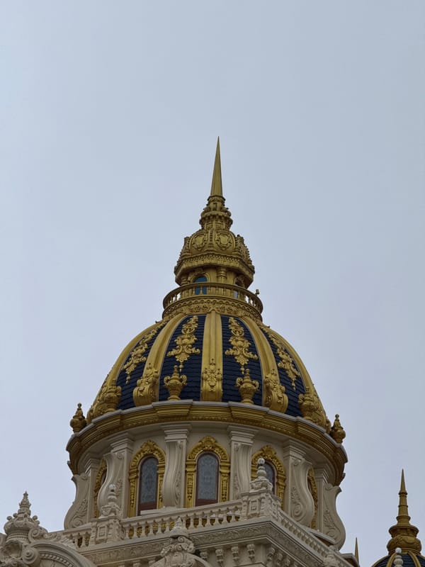 Ornate gilded dome and rainy streets in Da Lat
