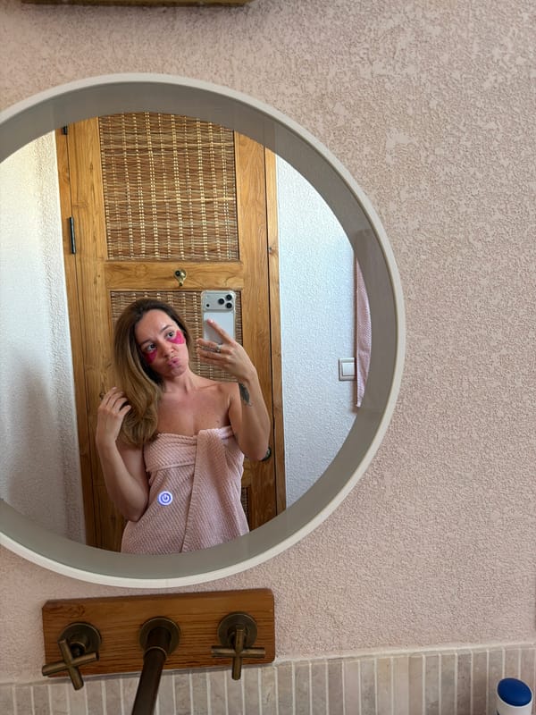 Woman takes morning selfies in Mengwi bathroom wearing pink beauty patches