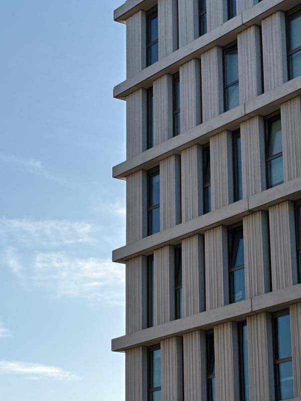 Brutalist concrete facade in Bruges, shot from below
