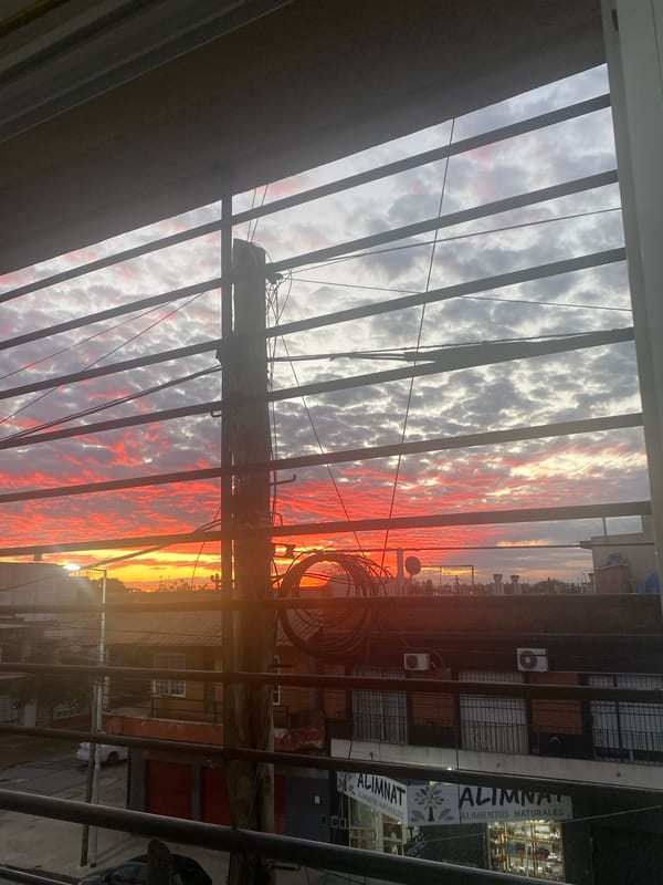 Sunset viewed through metal structure in Wilde, Argentina