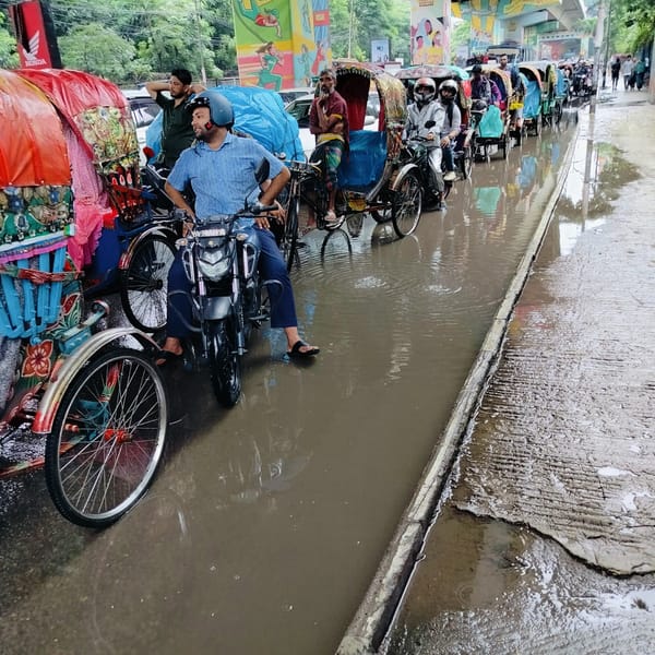 Overpass construction and rainy street life in Dhaka