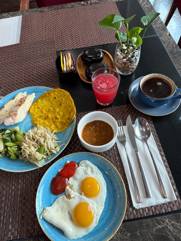 Breakfast scene documented in South Jakarta with coffee, plant