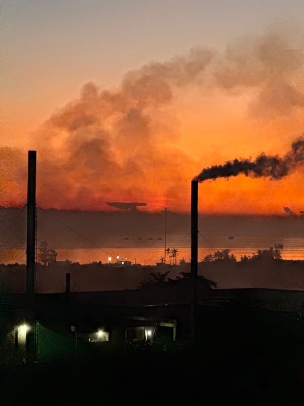 Smokestacks and fishing boats at sunset, Lý Sơn Island