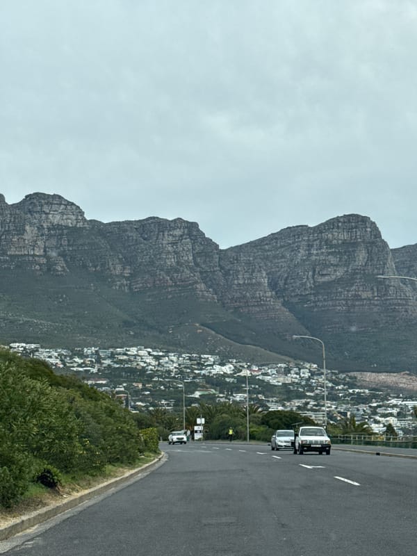 White trucks travel road near Table Mountain, Cape Town