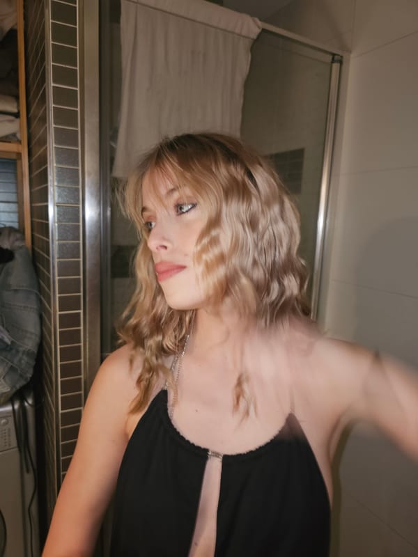 Blonde woman in pensive pose captured at unknown location