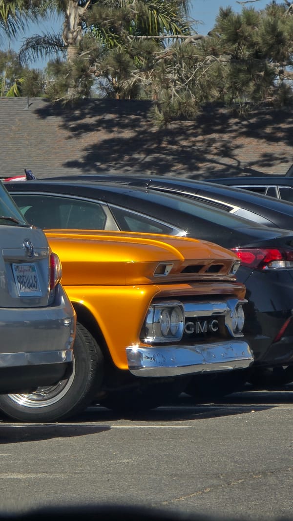 Vintage orange GMC pickup parked in Encinitas lot