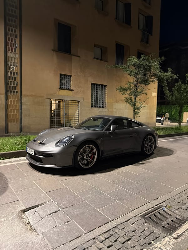 Evening dining documented at Milan restaurant, sports car nearby
