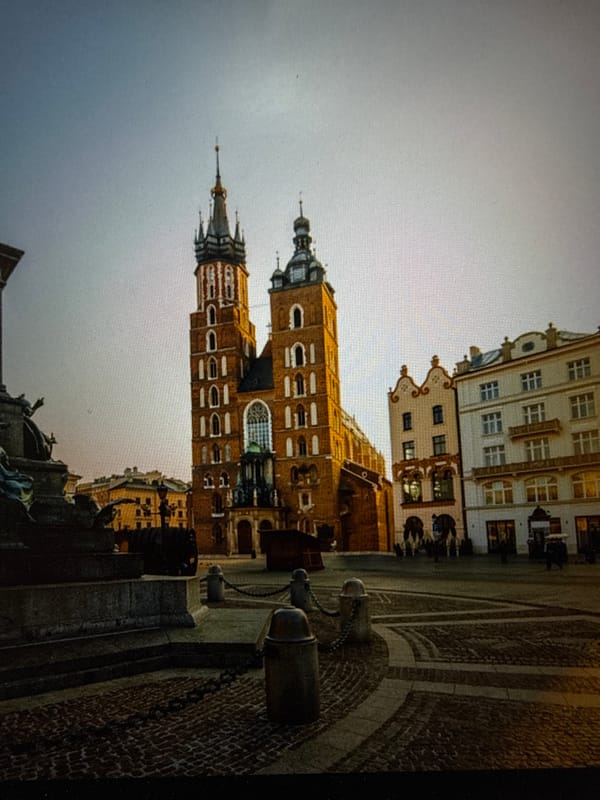 Morning documentation of Kraków basilica and waterfront reflections in Poland